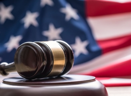 a court gavel in front of the united states flag